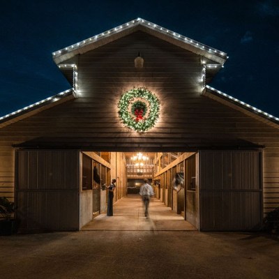 a clock sitting in front of a house