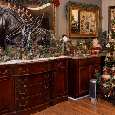 a room filled with furniture and vase of flowers