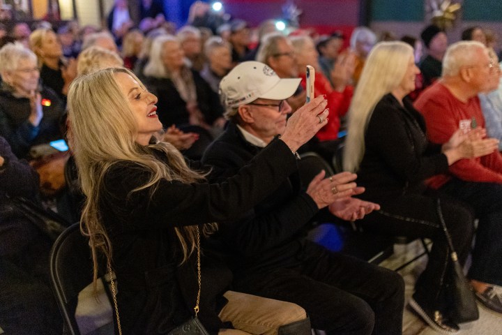 a group of people sitting in front of a crowd