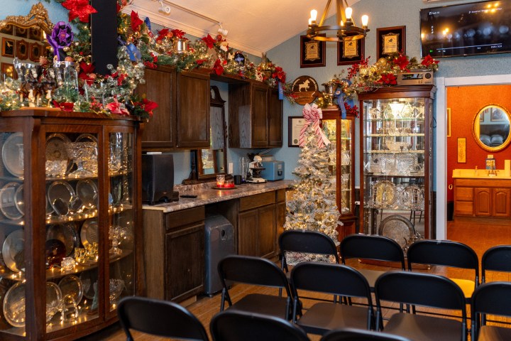 a room filled with furniture and a fire place sitting in a chair